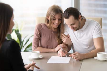 real estate couple signing