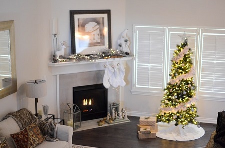 living room with a christmas tree near a fireplace